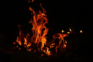 uncontrollable Fire and oil lamp fire flames on one single picture with orange / red / black and white color fire flame with black background.