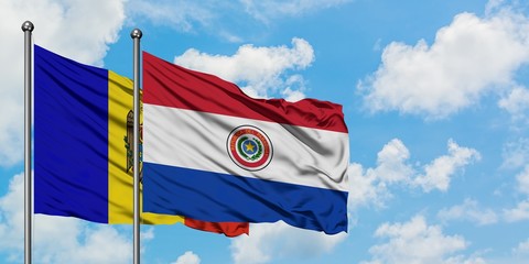 Moldova and Paraguay flag waving in the wind against white cloudy blue sky together. Diplomacy concept, international relations.