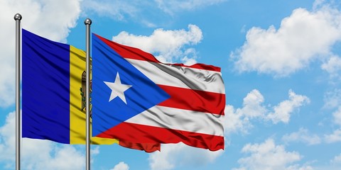 Moldova and Puerto Rico flag waving in the wind against white cloudy blue sky together. Diplomacy concept, international relations.