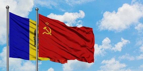Moldova and Soviet Union flag waving in the wind against white cloudy blue sky together. Diplomacy concept, international relations.