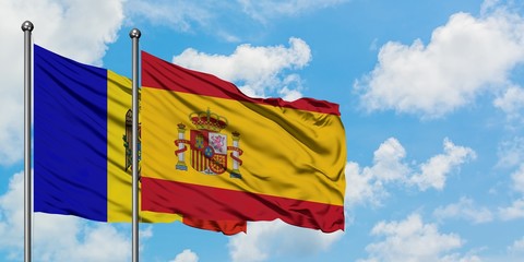 Moldova and Spain flag waving in the wind against white cloudy blue sky together. Diplomacy concept, international relations.