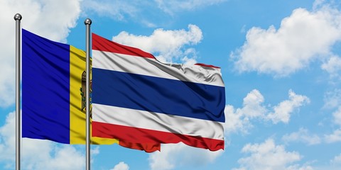 Moldova and Thailand flag waving in the wind against white cloudy blue sky together. Diplomacy concept, international relations.