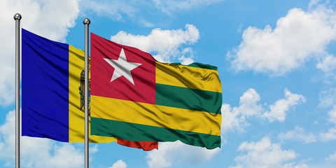 Moldova and Togo flag waving in the wind against white cloudy blue sky together. Diplomacy concept, international relations.