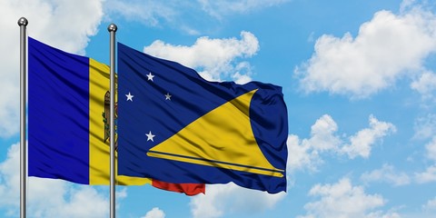 Moldova and Tokelau flag waving in the wind against white cloudy blue sky together. Diplomacy concept, international relations.
