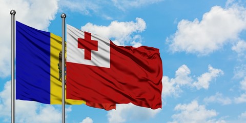 Moldova and Tonga flag waving in the wind against white cloudy blue sky together. Diplomacy concept, international relations.