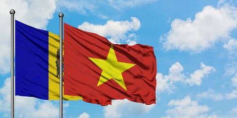 Moldova and Vietnam flag waving in the wind against white cloudy blue sky together. Diplomacy concept, international relations.