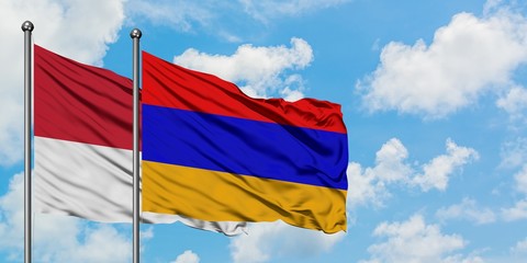 Monaco and Armenia flag waving in the wind against white cloudy blue sky together. Diplomacy concept, international relations.