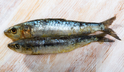 Obraz premium Salted sardines on wooden surface