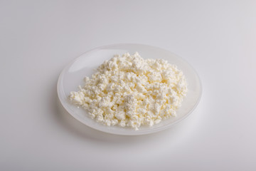 Granular cottage cheese on a white plate