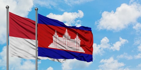 Monaco and Cambodia flag waving in the wind against white cloudy blue sky together. Diplomacy concept, international relations.