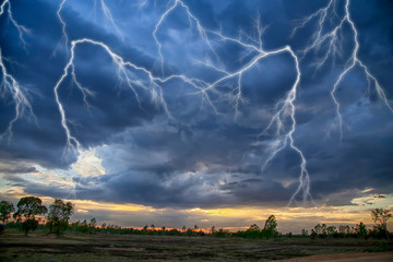 The sky is raging with rain and lightning.The sky is during the monsoon season and it is raining.