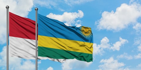 Monaco and Rwanda flag waving in the wind against white cloudy blue sky together. Diplomacy concept, international relations.