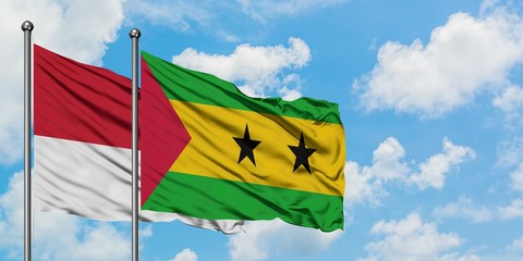 Monaco and Sao Tome And Principe flag waving in the wind against white cloudy blue sky together. Diplomacy concept, international relations.