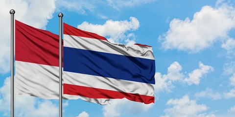 Monaco and Thailand flag waving in the wind against white cloudy blue sky together. Diplomacy concept, international relations.