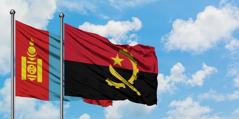 Mongolia and Angola flag waving in the wind against white cloudy blue sky together. Diplomacy concept, international relations.