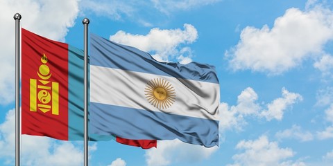 Mongolia and Argentina flag waving in the wind against white cloudy blue sky together. Diplomacy concept, international relations.