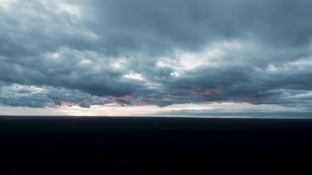 An epic aerial shot towards the sunset with an aesthetic cloudy sky on an autumn day.