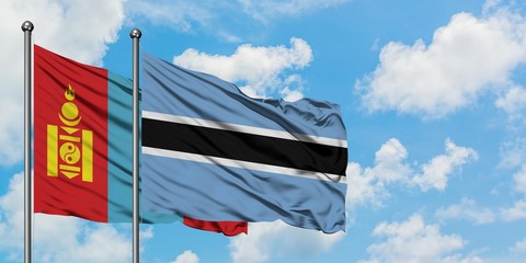 Mongolia and Botswana flag waving in the wind against white cloudy blue sky together. Diplomacy concept, international relations.