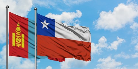 Mongolia and Chile flag waving in the wind against white cloudy blue sky together. Diplomacy concept, international relations.