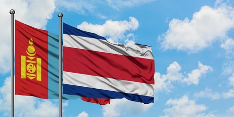 Mongolia and Costa Rica flag waving in the wind against white cloudy blue sky together. Diplomacy concept, international relations.