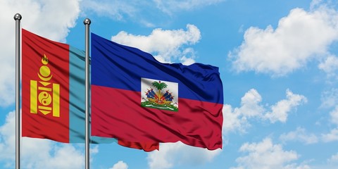 Mongolia and Haiti flag waving in the wind against white cloudy blue sky together. Diplomacy...