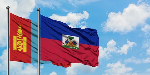 Mongolia and Haiti flag waving in the wind against white cloudy blue sky together. Diplomacy concept, international relations.
