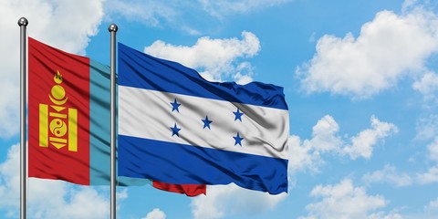 Mongolia and Honduras flag waving in the wind against white cloudy blue sky together. Diplomacy concept, international relations.
