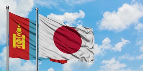 Mongolia and Japan flag waving in the wind against white cloudy blue sky together. Diplomacy concept, international relations.