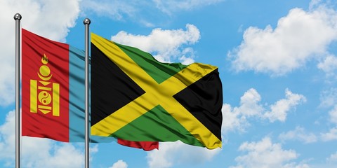Mongolia and Jamaica flag waving in the wind against white cloudy blue sky together. Diplomacy concept, international relations.