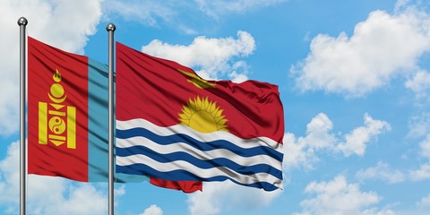 Mongolia and Kiribati flag waving in the wind against white cloudy blue sky together. Diplomacy concept, international relations.
