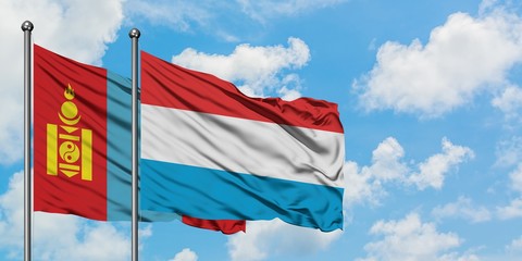 Mongolia and Luxembourg flag waving in the wind against white cloudy blue sky together. Diplomacy concept, international relations.