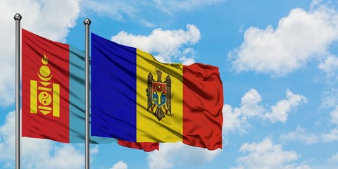Mongolia and Moldova flag waving in the wind against white cloudy blue sky together. Diplomacy concept, international relations.
