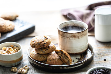 Homemade cookies with nuts and hot coffee in a ceramic cup