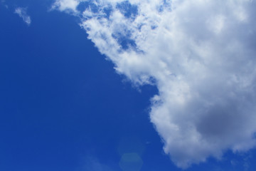 Naklejka na ściany i meble Blue sky with white clouds and sun.