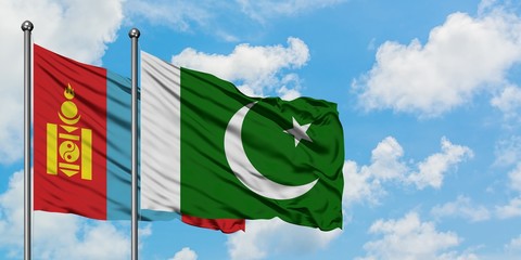 Mongolia and Pakistan flag waving in the wind against white cloudy blue sky together. Diplomacy concept, international relations.