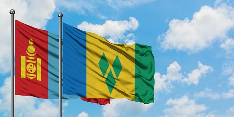 Mongolia and Saint Vincent And The Grenadines flag waving in the wind against white cloudy blue sky...