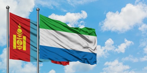Mongolia and Sierra Leone flag waving in the wind against white cloudy blue sky together. Diplomacy concept, international relations.