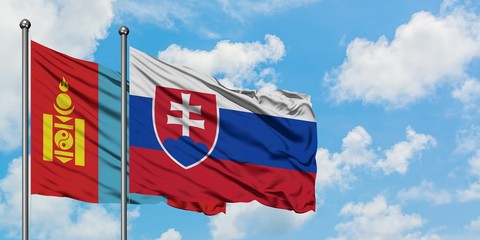 Mongolia and Slovakia flag waving in the wind against white cloudy blue sky together. Diplomacy concept, international relations.