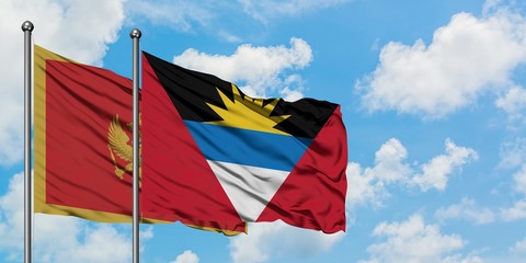 Montenegro and Antigua and Barbuda flag waving in the wind against white cloudy blue sky together. Diplomacy concept, international relations.