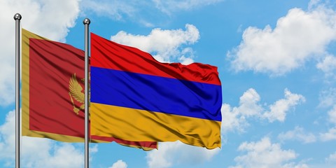 Montenegro and Armenia flag waving in the wind against white cloudy blue sky together. Diplomacy concept, international relations.