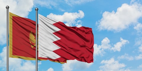 Montenegro and Bahrain flag waving in the wind against white cloudy blue sky together. Diplomacy concept, international relations.