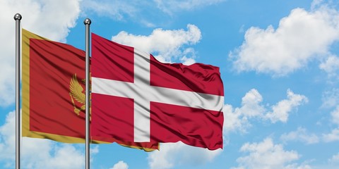 Montenegro and Denmark flag waving in the wind against white cloudy blue sky together. Diplomacy concept, international relations.