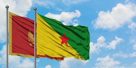 Montenegro and French Guiana flag waving in the wind against white cloudy blue sky together. Diplomacy concept, international relations.