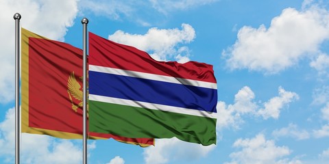 Montenegro and Gambia flag waving in the wind against white cloudy blue sky together. Diplomacy concept, international relations.