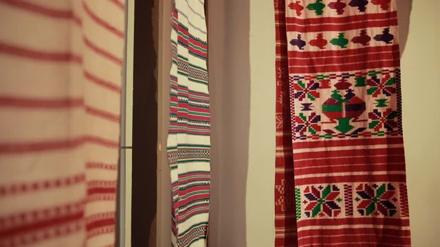 Amazing market in traditionally ukrainian fair where are sellint clothes: rushnyky. Costumers can buy something. Staff of different bright colors, materials and shapes.
