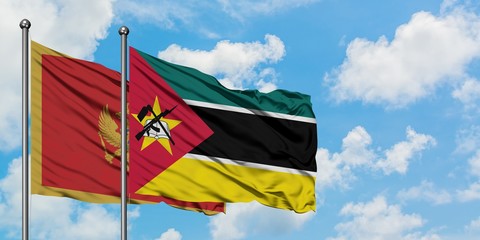 Montenegro and Mozambique flag waving in the wind against white cloudy blue sky together. Diplomacy concept, international relations.