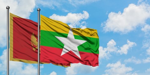 Montenegro and Myanmar flag waving in the wind against white cloudy blue sky together. Diplomacy concept, international relations.
