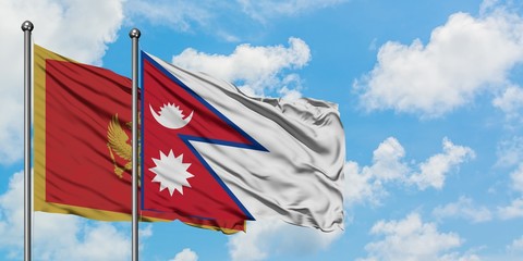 Montenegro and Nepal flag waving in the wind against white cloudy blue sky together. Diplomacy concept, international relations.