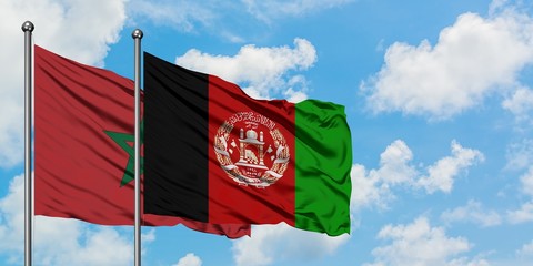 Morocco and Afghanistan flag waving in the wind against white cloudy blue sky together. Diplomacy concept, international relations.