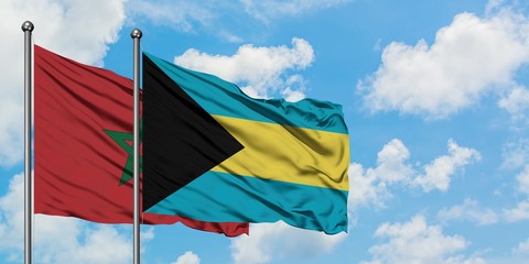 Morocco and Bahamas flag waving in the wind against white cloudy blue sky together. Diplomacy concept, international relations.